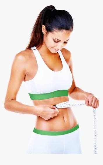 Woman in activewear measuring her waist while following a healthy lifestyle routine